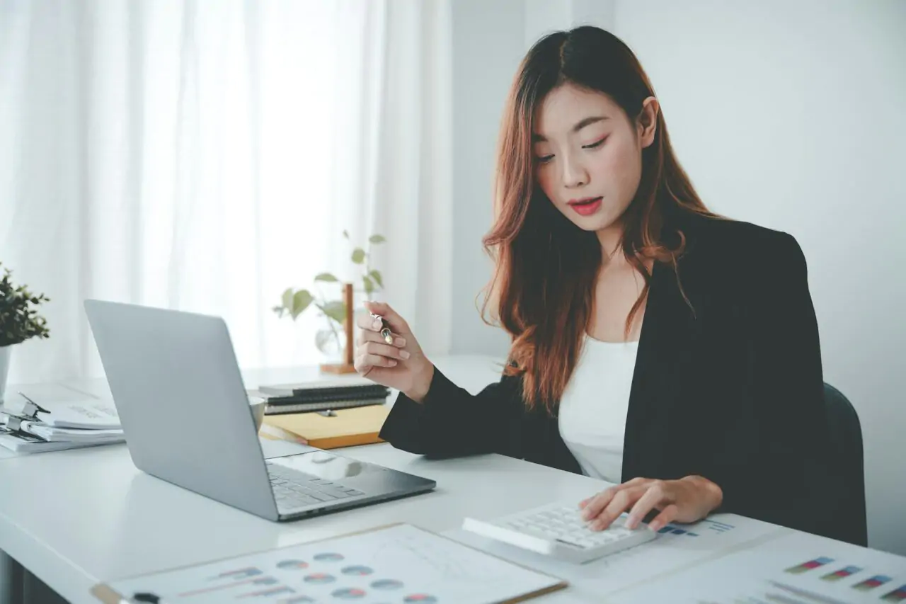 Asian Woman Working On Customer Documents Finance Accounting Taxes In The Office 1 4